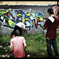 What are similar characteristics of graffiti and street art?